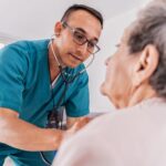 The nurse listened to the heart of a high woman during medical communication